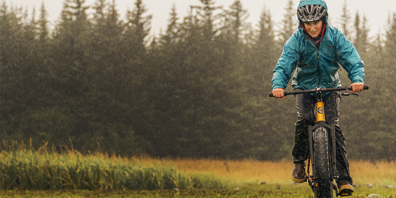 Woman biking in the rain